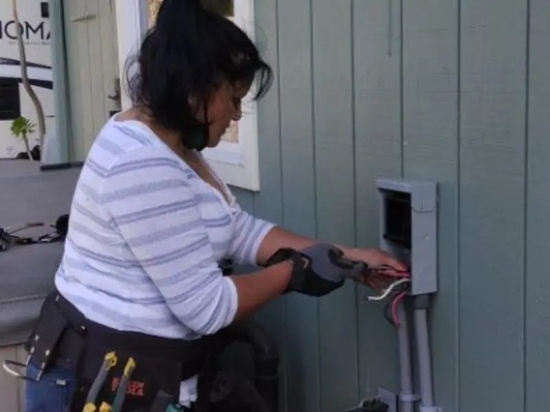Licensed electrician wiring an exterior subpanel in Pearl River